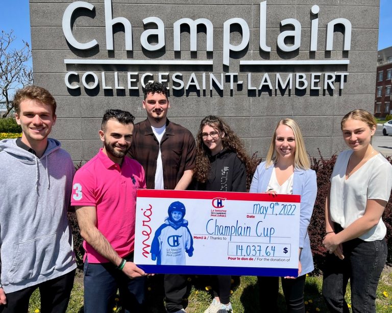 Students holding a large cheque.